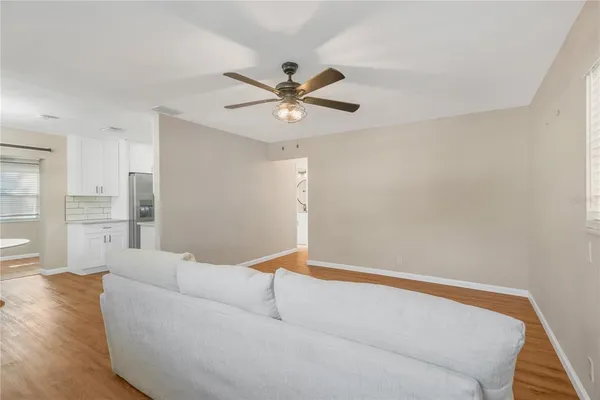 a living room with furniture and a ceiling fan