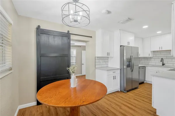 a kitchen with stainless steel appliances a refrigerator and microwave
