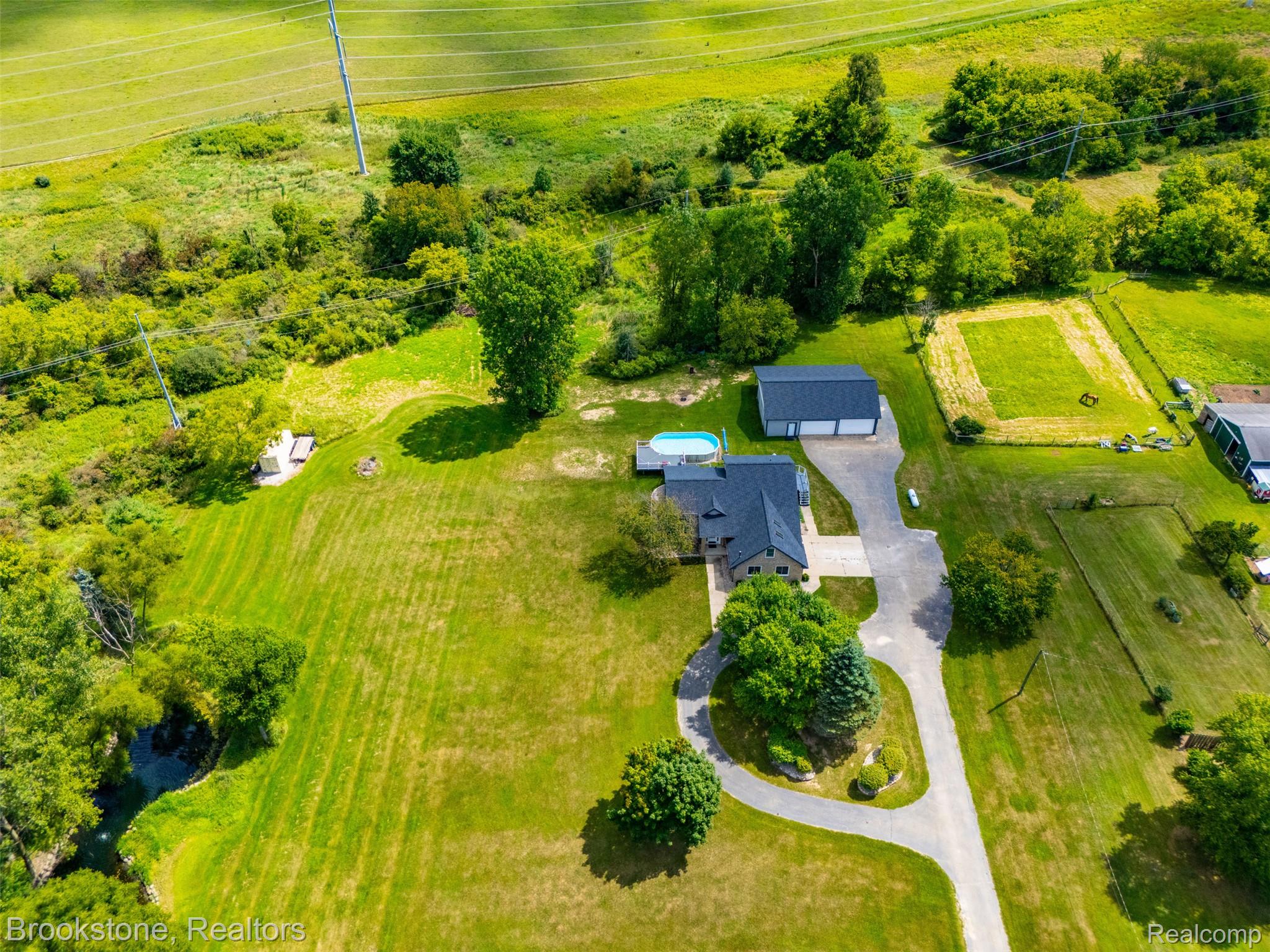 1775 Dutcher Road Howell, MI 48843 - Photo 40 of 41 Expansive property featuring a residence, detached garage, swimming pool, and a winding driveway