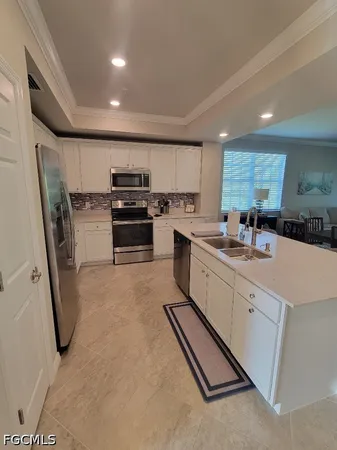 a large kitchen with stainless steel appliances granite countertop a sink stove and refrigerator