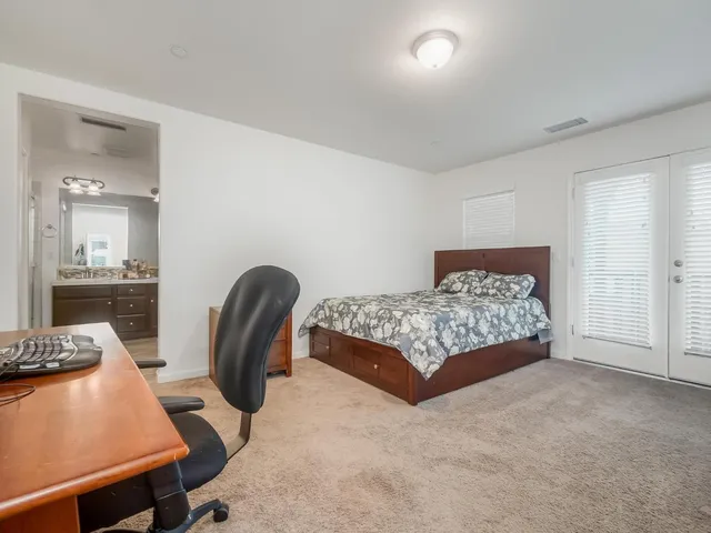 a bedroom with a bed and a table