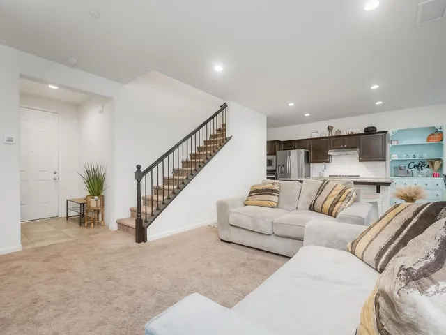 a living room with furniture and stairs