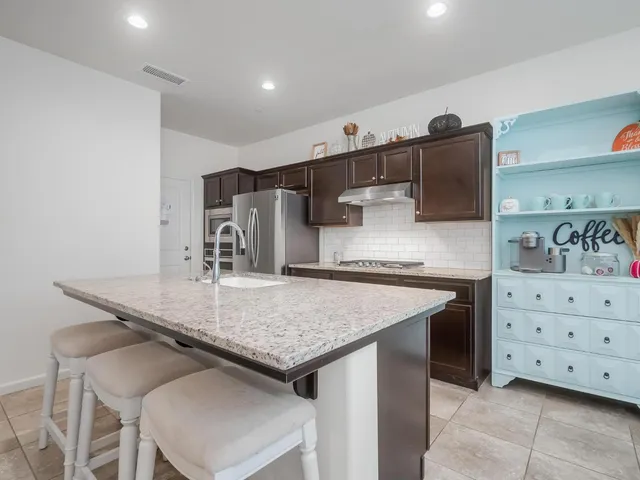 a kitchen with a stove a sink and a refrigerator