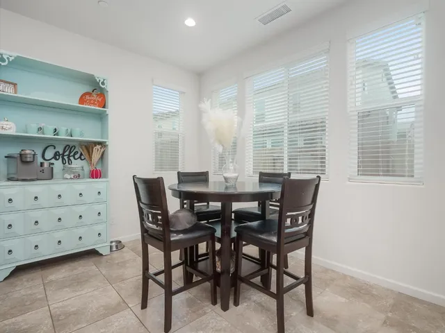 a view of a dining room with furniture and window