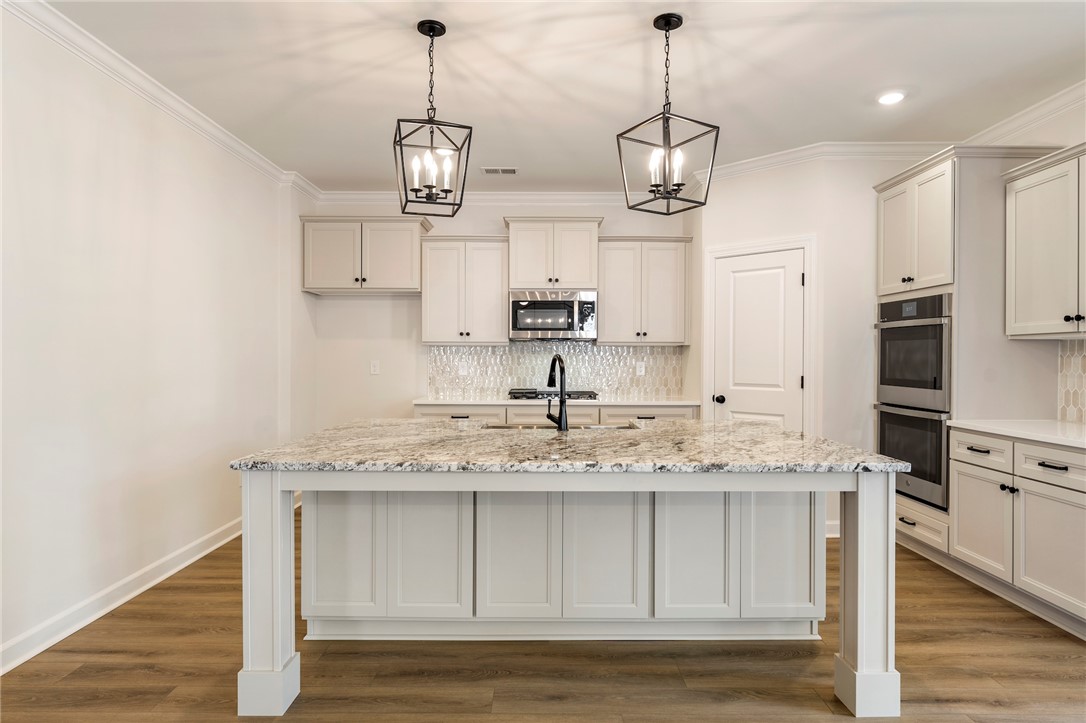 114 Lakeside Drive Anderson, SC 29621 - Photo 11 of 37 This bright kitchen features a spacious island, elegant countertops, and modern appliances.