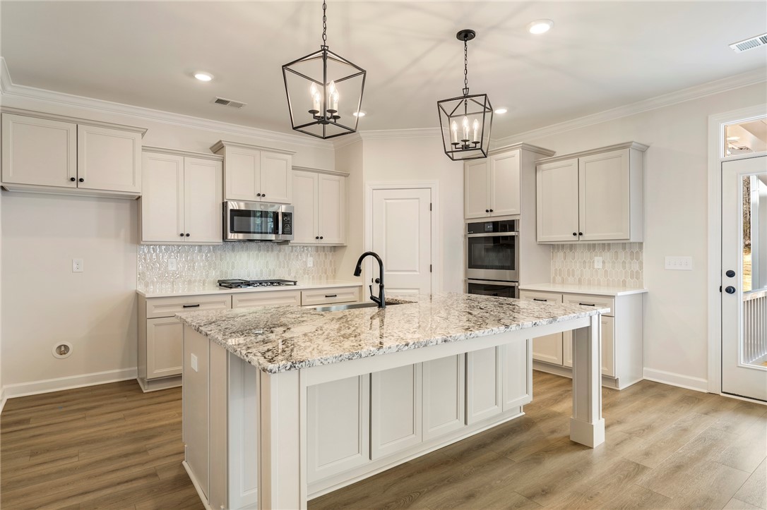 114 Lakeside Drive Anderson, SC 29621 - Photo 12 of 37 This bright kitchen features sleek appliances and a spacious island, perfect for culinary adventures.