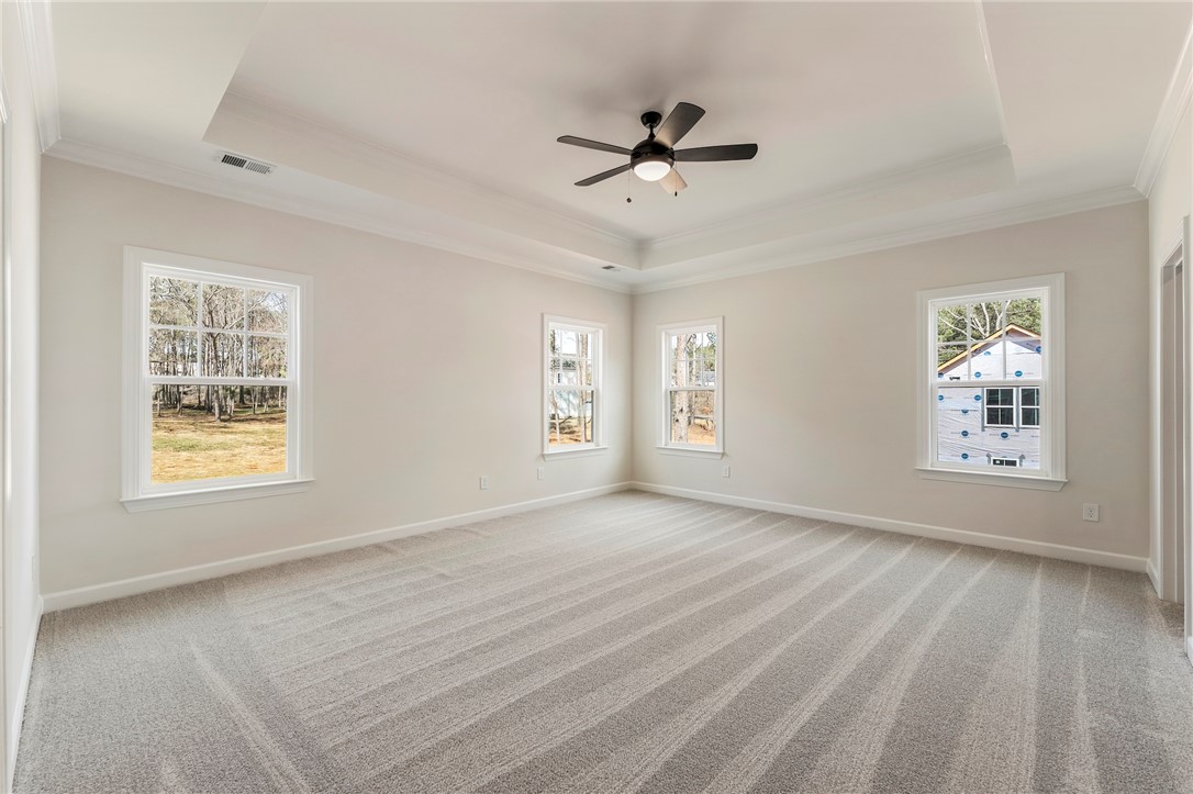 114 Lakeside Drive Anderson, SC 29621 - Photo 17 of 37 This spacious primary bedroom features soft carpeting and ample natural light through multiple windows.