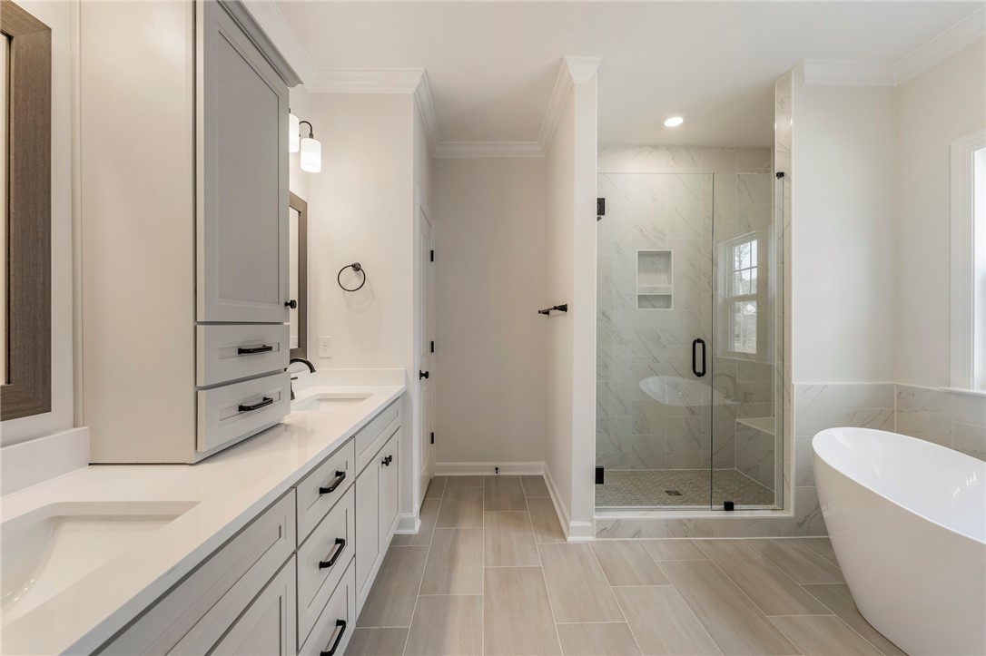 114 Lakeside Drive Anderson, SC 29621 - Photo 20 of 37 This primary bathroom boasts a dual vanity, a spacious shower, and a freestanding tub.