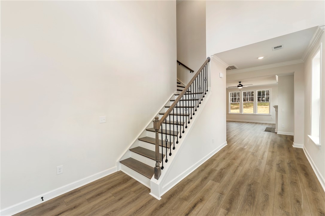 114 Lakeside Drive Anderson, SC 29621 - Photo 2 of 37 This inviting entry features a beautiful staircase and opens into a sunlit living space.