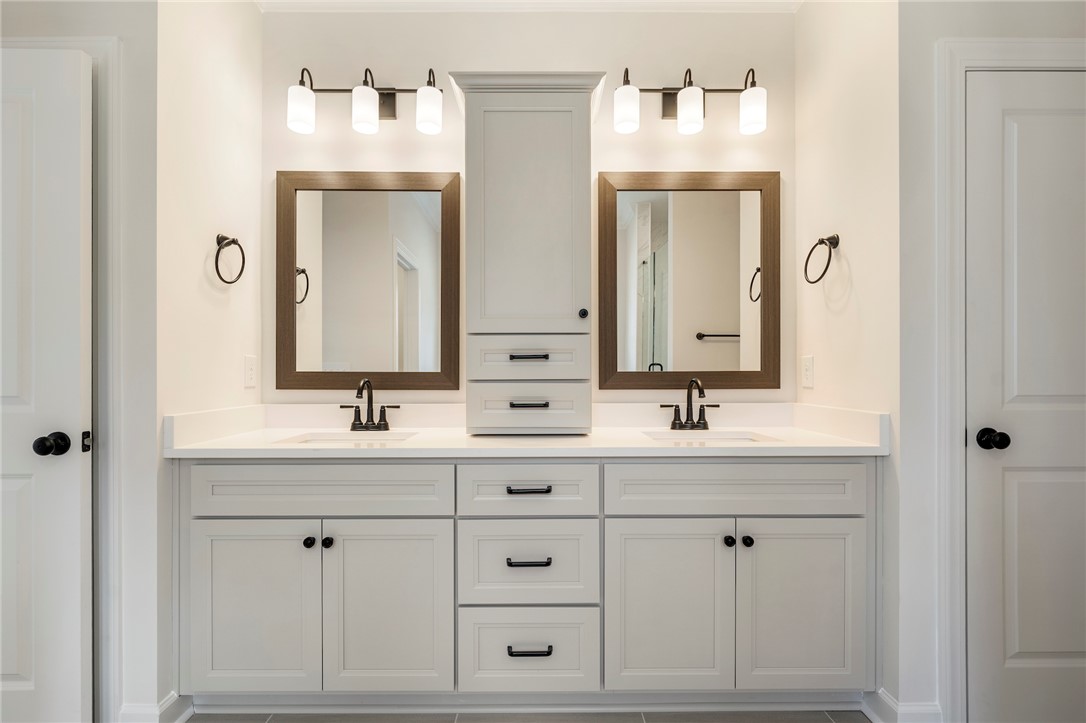 114 Lakeside Drive Anderson, SC 29621 - Photo 21 of 37 This modern bathroom features a double vanity, ample storage, and sleek fixtures.