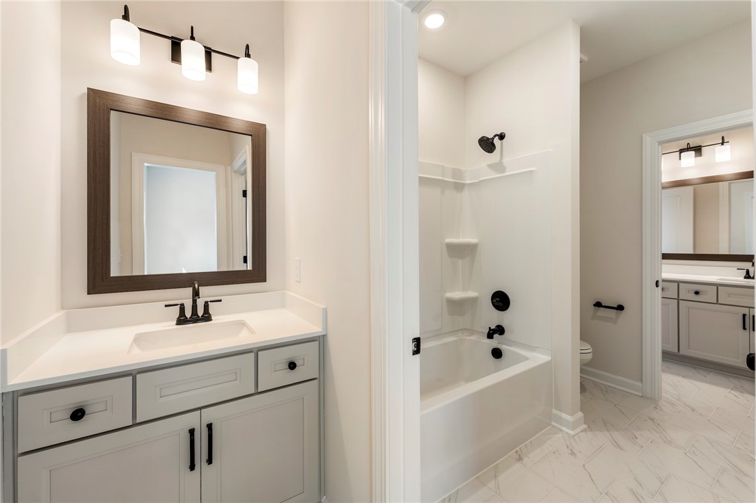 114 Lakeside Drive Anderson, SC 29621 - Photo 28 of 37 This bright bathroom features sleek vanity and modern fixtures.