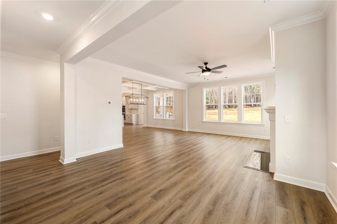 114 Lakeside Drive Anderson, SC 29621 - Photo 3 of 37 This expansive great room flows seamlessly, showcasing elegant crown molding and rich hardwood flooring.