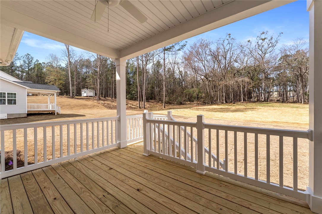 114 Lakeside Drive Anderson, SC 29621 - Photo 36 of 37 This inviting covered porch offers serene outdoor living amidst a natural landscape.