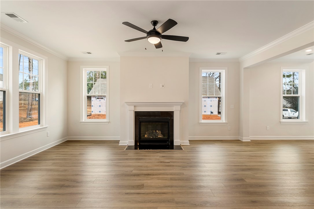 114 Lakeside Drive Anderson, SC 29621 - Photo 5 of 37 This bright living space features elegant hardwood flooring, a cozy fireplace, and abundant natural light.