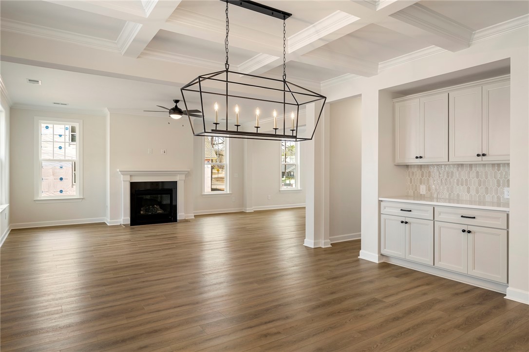 114 Lakeside Drive Anderson, SC 29621 - Photo 9 of 37 This expansive great room features coffered ceilings, warm wood flooring, and a cozy fireplace.
