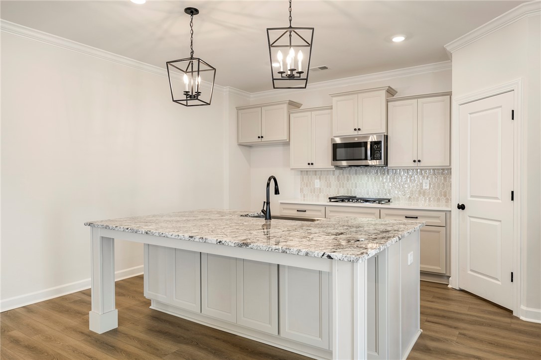 114 Lakeside Drive Anderson, SC 29621 - Photo 10 of 37 This bright and airy kitchen boasts a functional island and modern appliances, perfect for culinary endeavors.