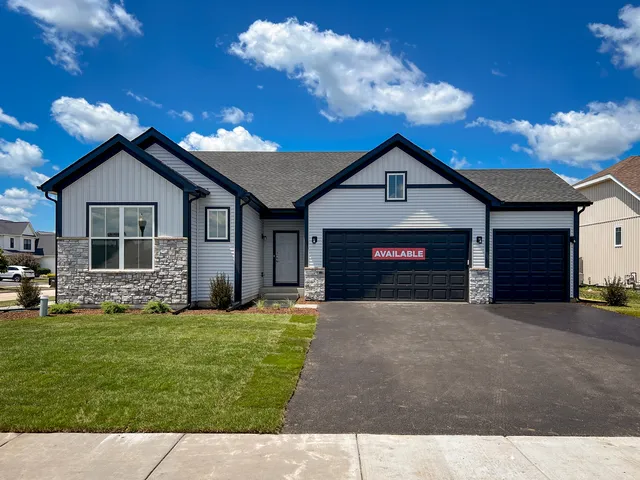 a front view of a house with a garden and yard