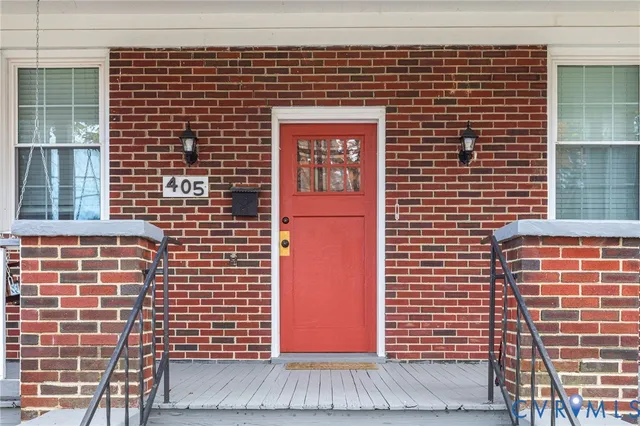 a kitchen with white cabinets a sink dishwasher and a stove with wooden floor