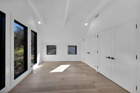 a view of entryway with window and wooden floor