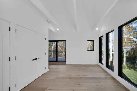 a view of a small space with wooden floor and windows