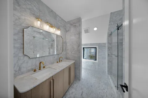 a bathroom with a granite countertop shower and a sink