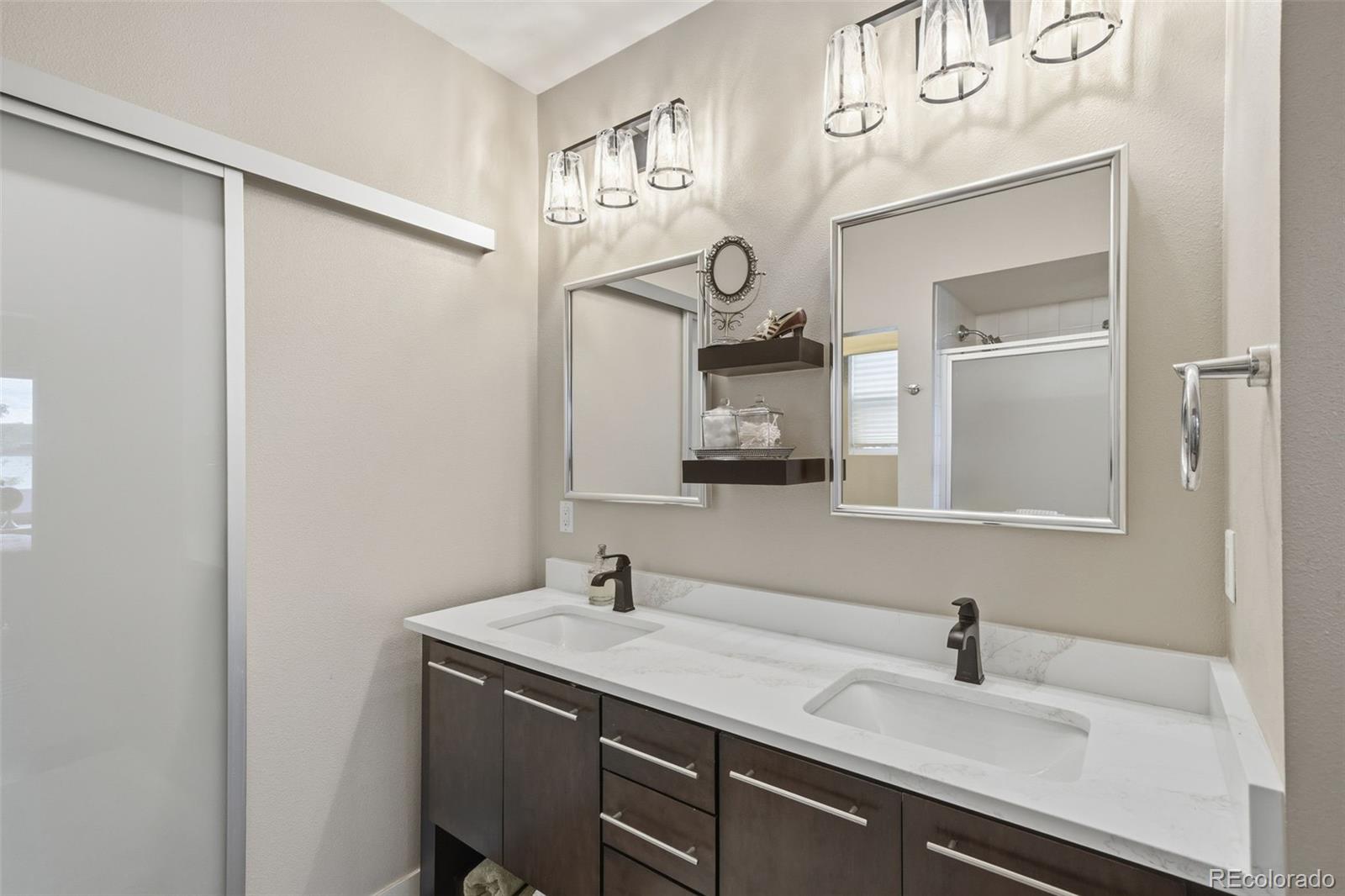 9602 Dunning Circle Highlands Ranch, CO 80126 - Photo 10 of 50 a bathroom with a sink and a mirror