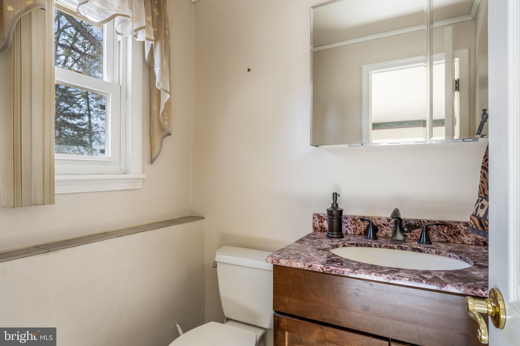 6 Morgan Road Aston, PA 19014 - Photo 22 of 33 a bathroom with a granite countertop sink and a mirror