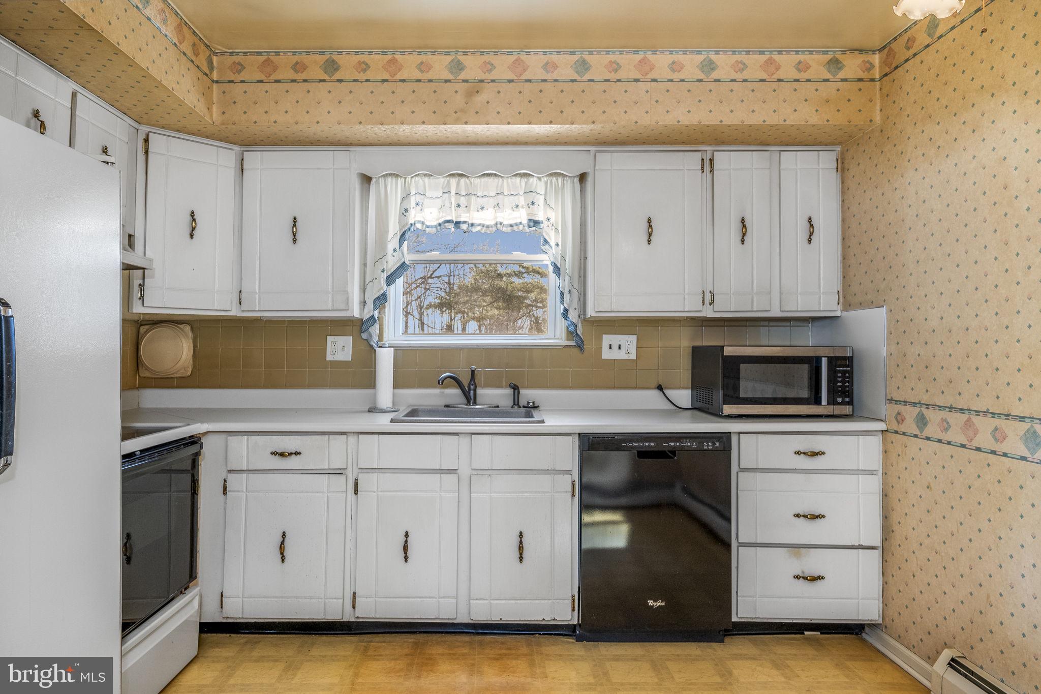 6 Morgan Road Aston, PA 19014 - Photo 6 of 33 a kitchen with stainless steel appliances granite countertop a stove a sink and a microwave