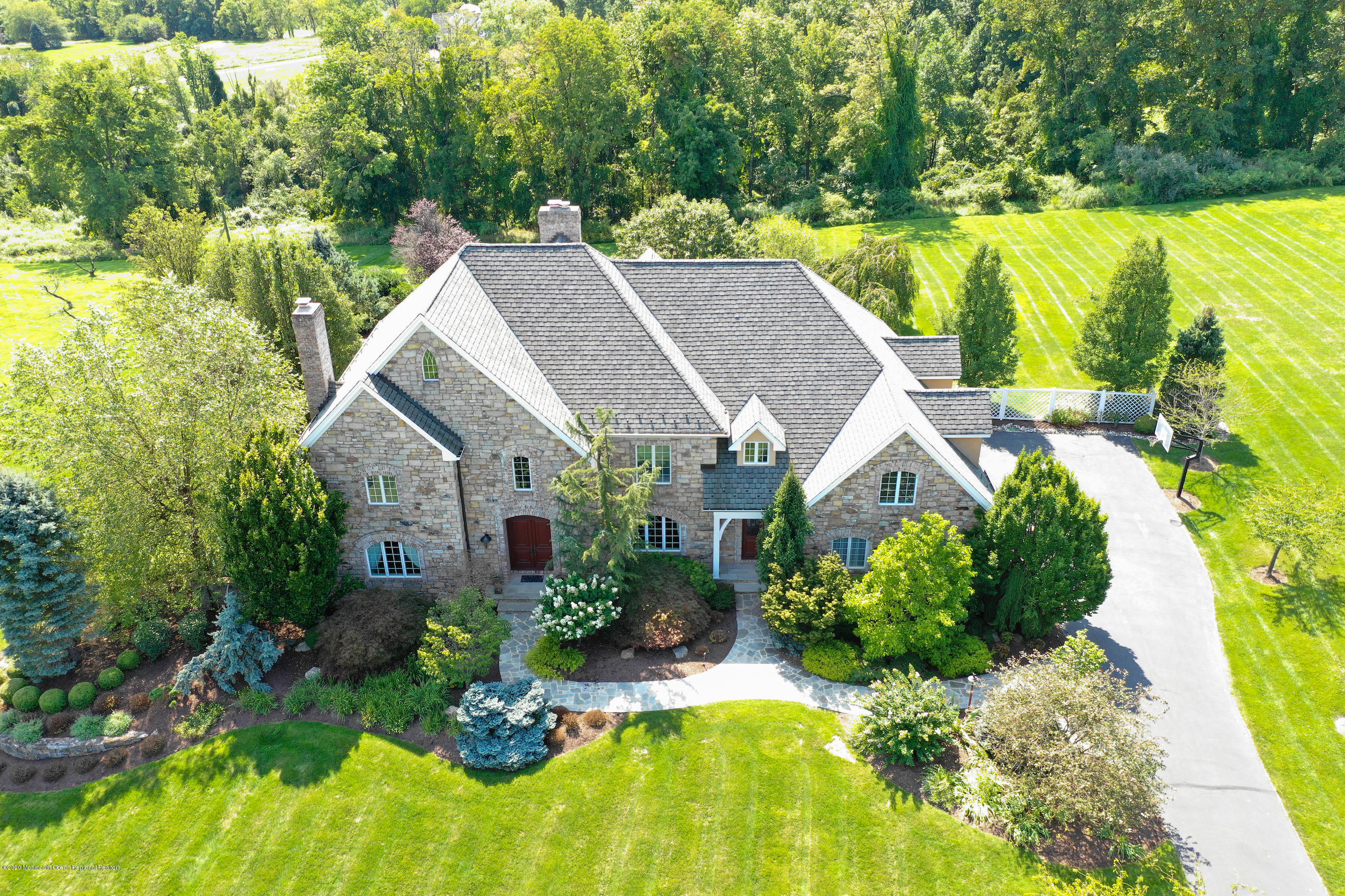 a view of a house with a yard and potted plants