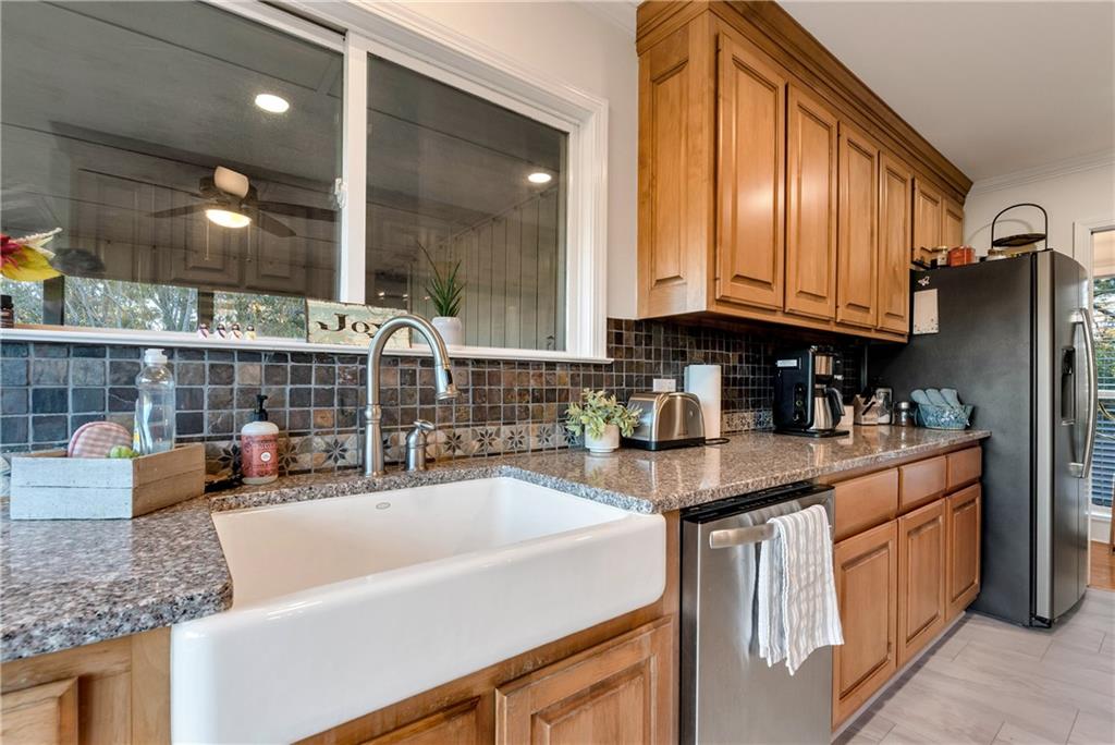 962 Woodbrier Sautee Nacoochee, GA 30571 - Photo 24 of 52 a kitchen with stainless steel appliances granite countertop a sink a stove and a wooden cabinets
