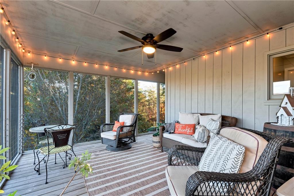 962 Woodbrier Sautee Nacoochee, GA 30571 - Photo 26 of 52 a living room with furniture a ceiling fan and a large window