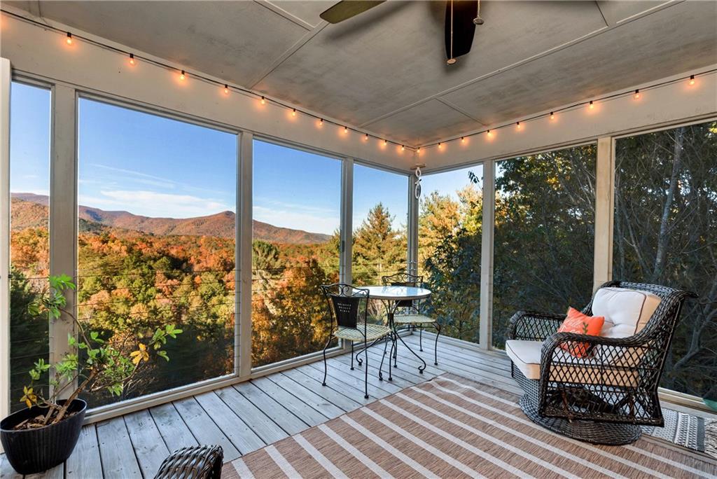 962 Woodbrier Sautee Nacoochee, GA 30571 - Photo 28 of 52 a balcony with furniture and wooden floor