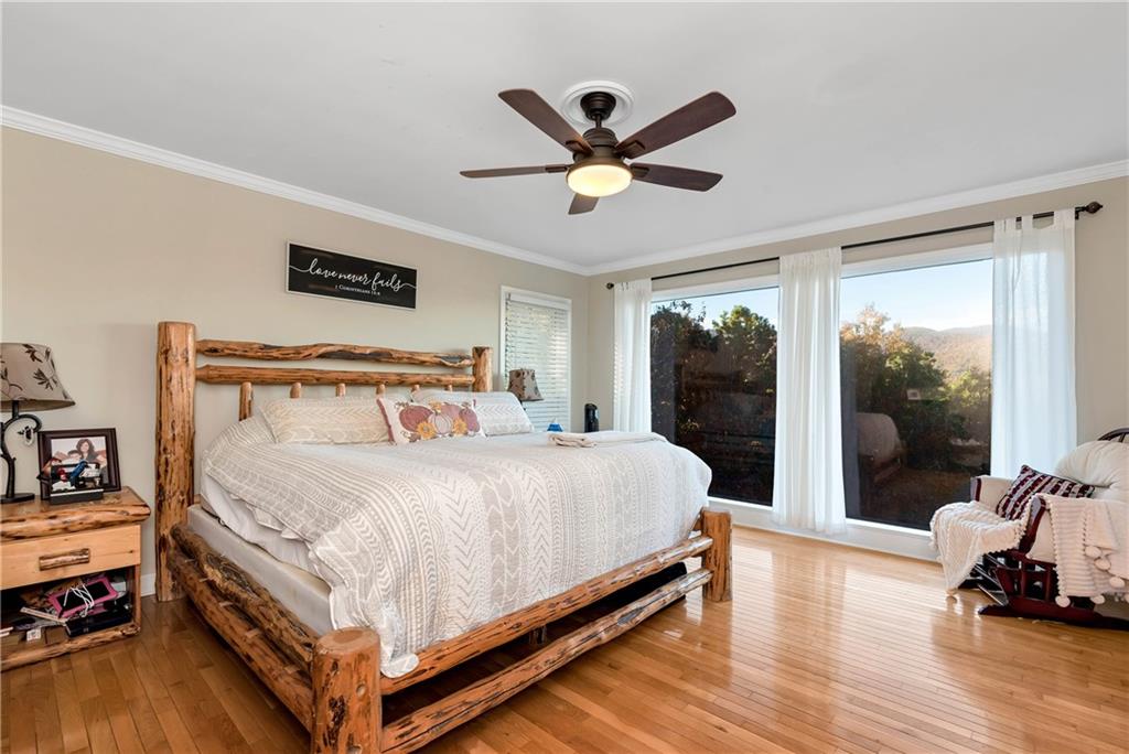 962 Woodbrier Sautee Nacoochee, GA 30571 - Photo 31 of 52 a bed sitting in a bedroom next to a window