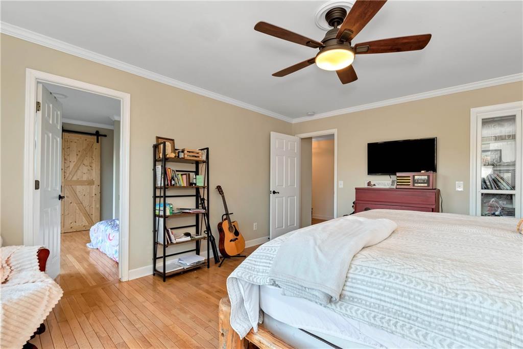 962 Woodbrier Sautee Nacoochee, GA 30571 - Photo 32 of 52 a bedroom with a bed window and a flat screen tv