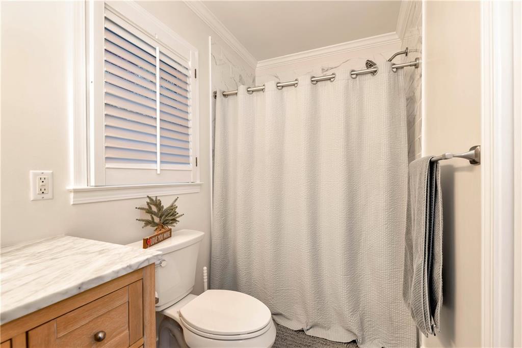 962 Woodbrier Sautee Nacoochee, GA 30571 - Photo 34 of 52 a bathroom with a sink a toilet a window and shower curtain