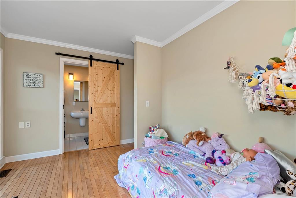 962 Woodbrier Sautee Nacoochee, GA 30571 - Photo 35 of 52 a bedroom with a bed and wooden floor