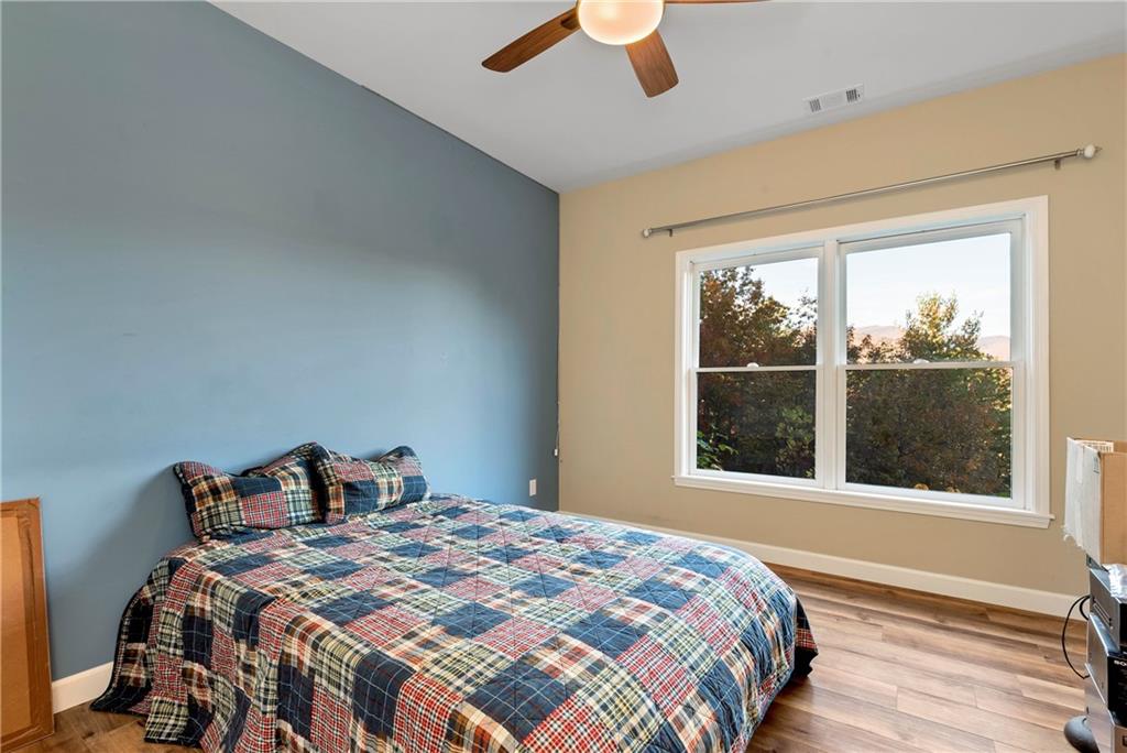962 Woodbrier Sautee Nacoochee, GA 30571 - Photo 50 of 52 a bedroom with a large bed and a large window
