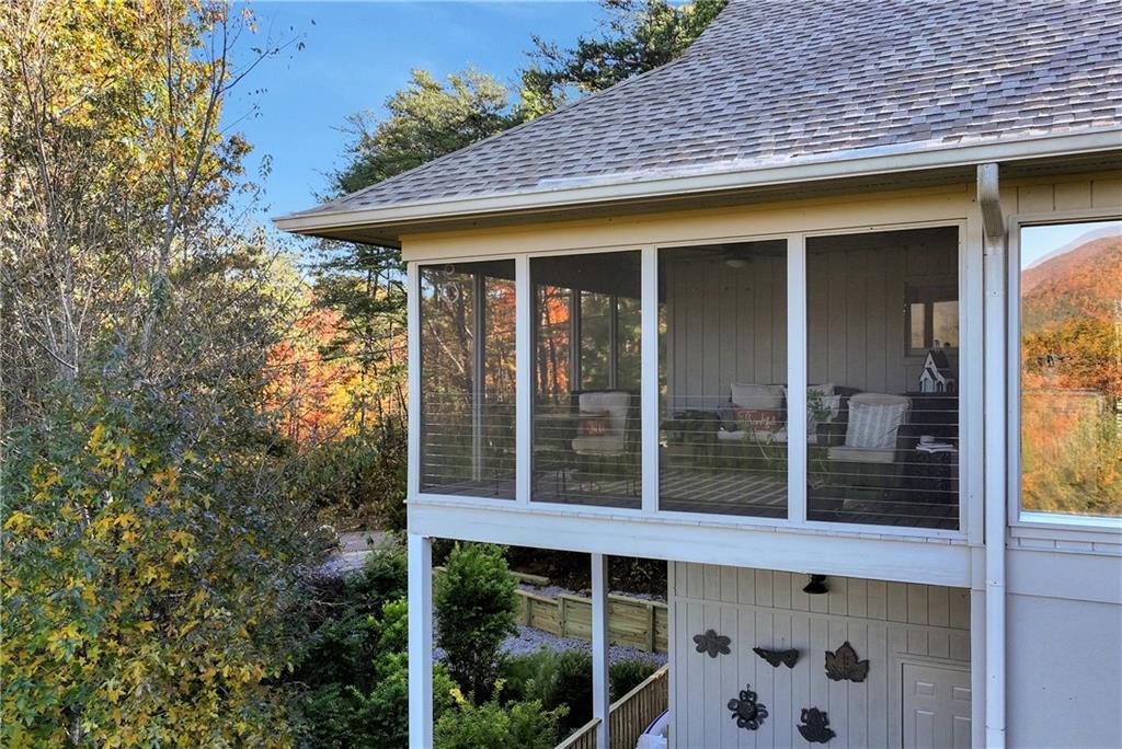 962 Woodbrier Sautee Nacoochee, GA 30571 - Photo 8 of 52 a view of a house with a large window and wooden fence