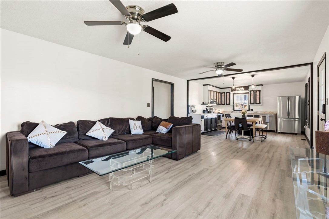 122 Latham Drive Anderson, SC 29621 - Photo 11 of 39 This bright, open-concept living space features durable flooring and seamlessly connects to a modern kitchen.
