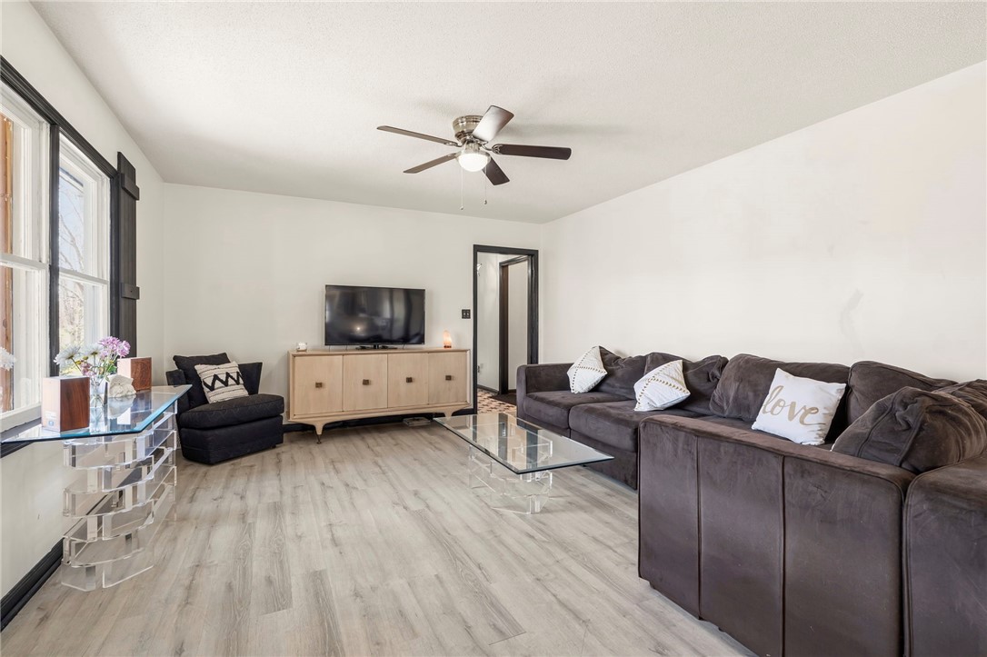 122 Latham Drive Anderson, SC 29621 - Photo 12 of 39 This bright living space features light wood-look flooring, creating an inviting and airy atmosphere.