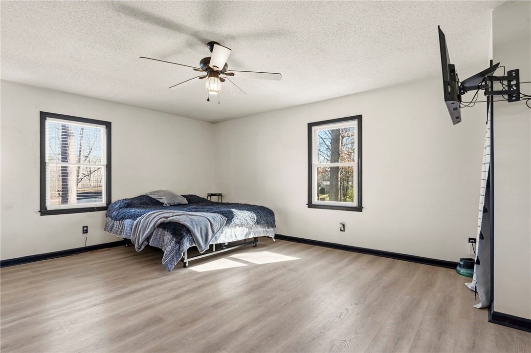 122 Latham Drive Anderson, SC 29621 - Photo 15 of 39 This airy bedroom features abundant natural light and durable flooring, creating a comfortable and inviting atmosphere.