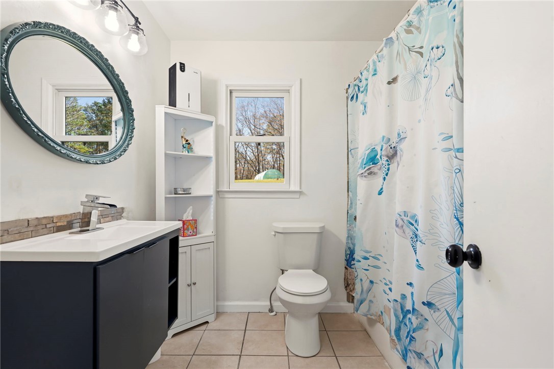 122 Latham Drive Anderson, SC 29621 - Photo 22 of 39 This bright bathroom features a modern vanity, elegant mirror, and serene tile flooring.