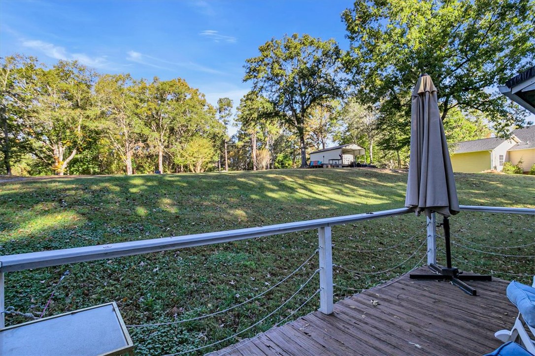 122 Latham Drive Anderson, SC 29621 - Photo 39 of 39 This spacious yard features a wooden deck and lush green grass.