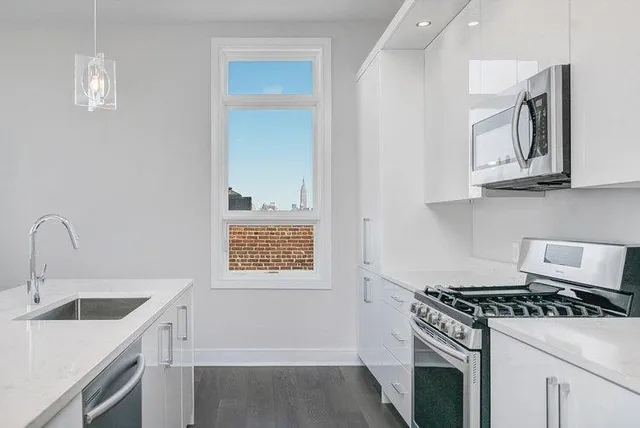 a kitchen with cabinets a stove and a sink