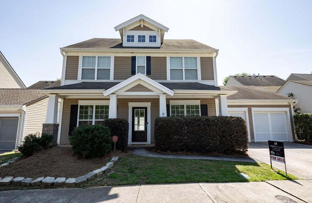 a front view of a house with garden