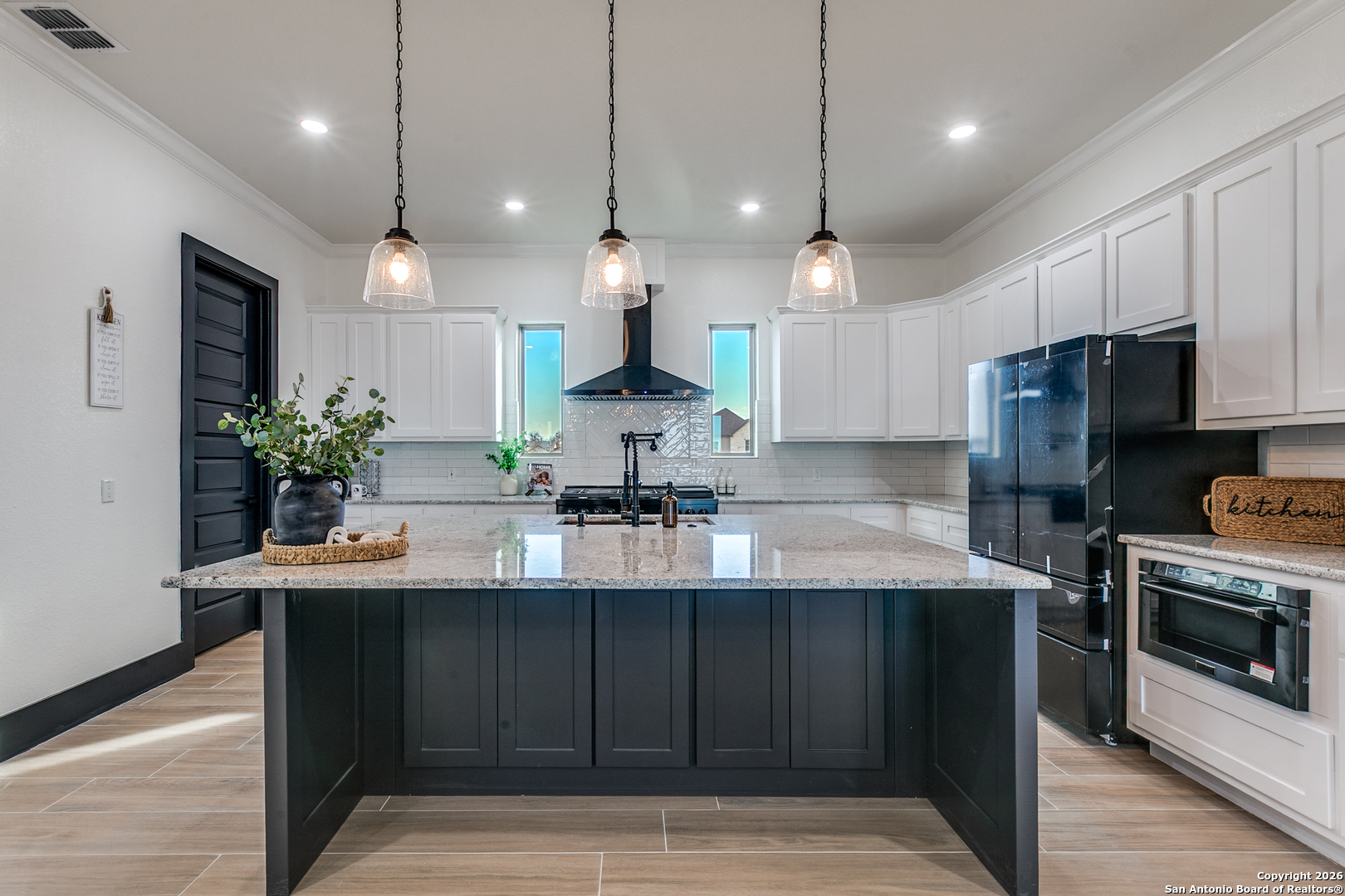 202 Venado Oaks Rio Medina, TX 78066 - Photo 14 of 37 a kitchen with kitchen island a counter space a sink appliances and cabinets