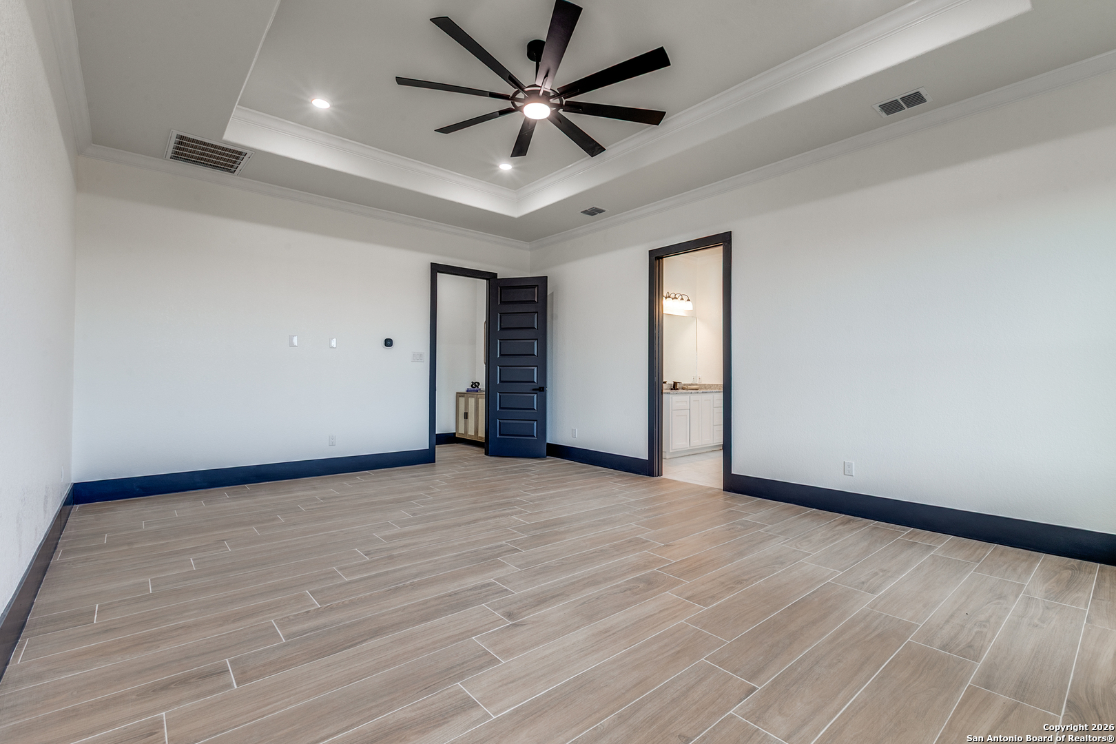202 Venado Oaks Rio Medina, TX 78066 - Photo 17 of 37 wooden floor in an empty room with a window