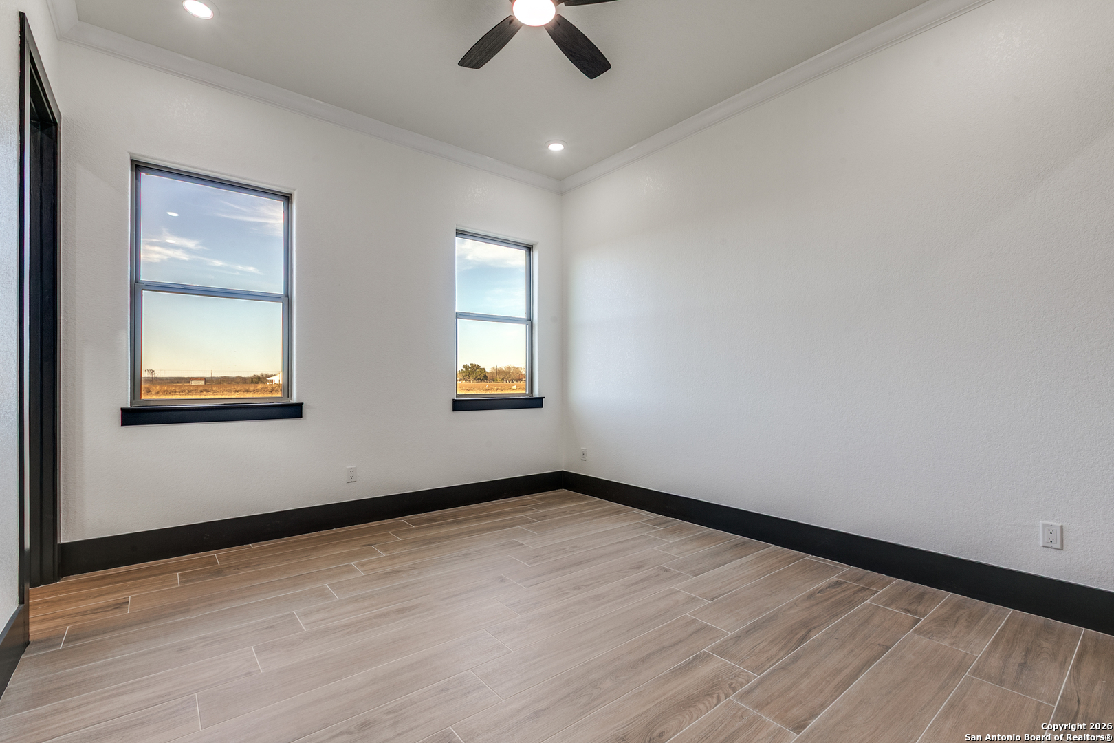 202 Venado Oaks Rio Medina, TX 78066 - Photo 21 of 37 wooden floor in an empty room with a window