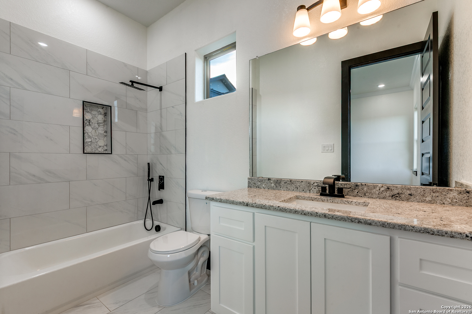 202 Venado Oaks Rio Medina, TX 78066 - Photo 23 of 37 a bathroom with a granite countertop sink toilet mirror and bathtub