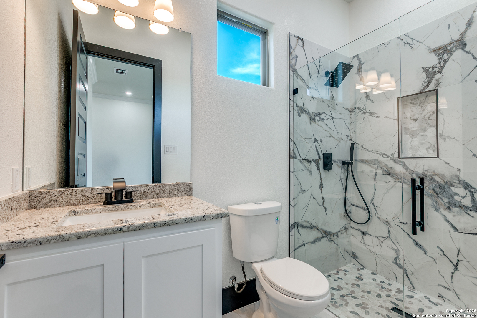 202 Venado Oaks Rio Medina, TX 78066 - Photo 24 of 37 a bathroom with a granite countertop toilet sink and shower